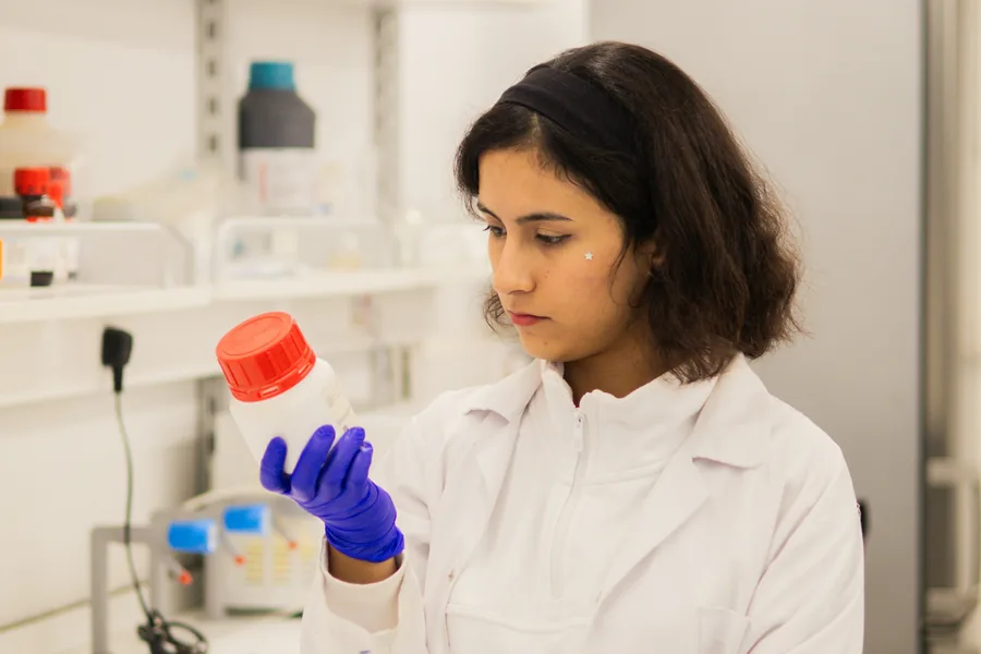 Laboratory researcher reviewing materials during scientific work